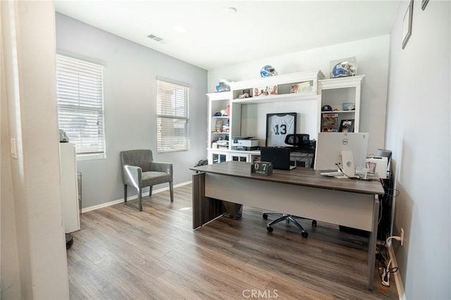 office with visible vents, baseboards, and wood finished floors