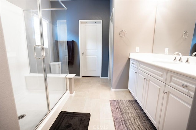 full bathroom featuring baseboards, vanity, and a shower stall