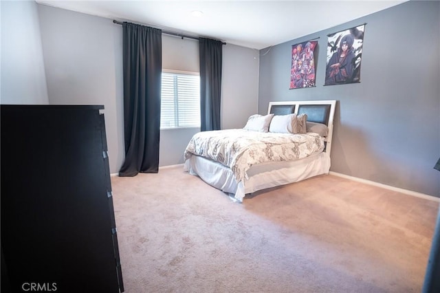 bedroom featuring carpet and baseboards