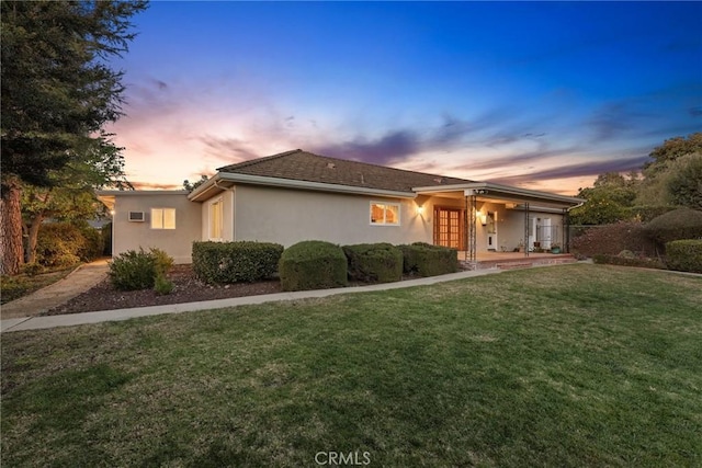 single story home with a front lawn and stucco siding