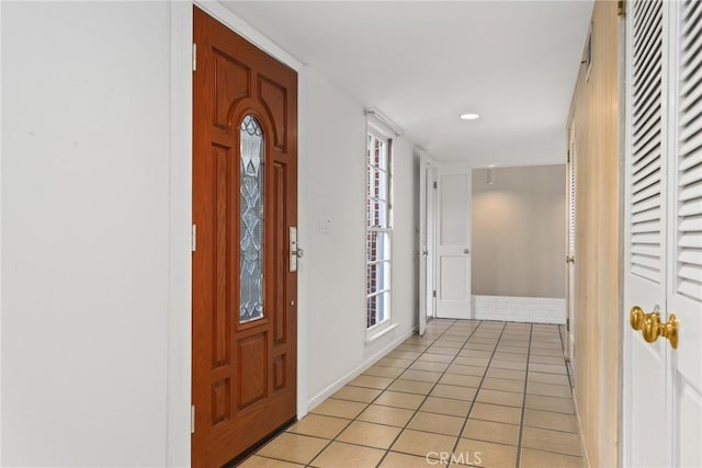 entrance foyer with light tile patterned floors and plenty of natural light