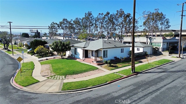 single story home featuring a front lawn and a residential view