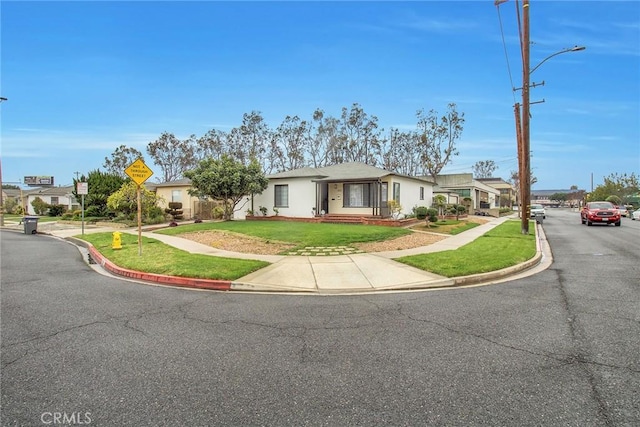 ranch-style house featuring a residential view and a front yard