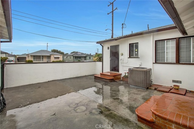 view of patio / terrace featuring central air condition unit and fence