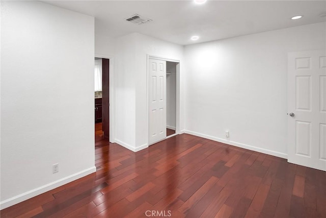 unfurnished bedroom featuring recessed lighting, visible vents, baseboards, and dark wood-style flooring