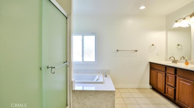 bathroom featuring a garden tub, double vanity, a shower with shower door, tile patterned floors, and a sink