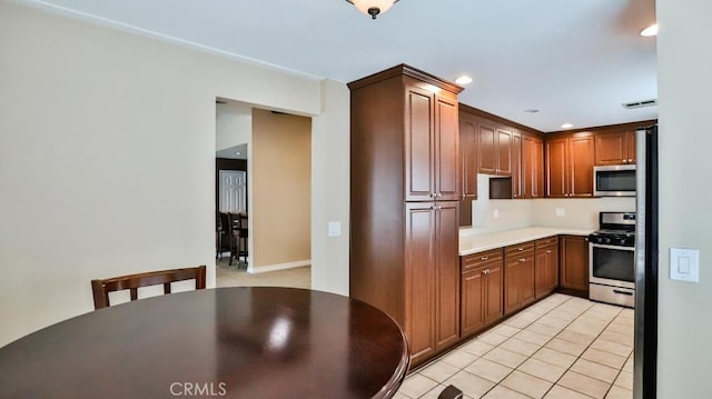 kitchen with visible vents, light countertops, light tile patterned floors, recessed lighting, and stainless steel appliances