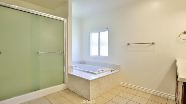 bathroom featuring tile patterned floors, a shower stall, and a garden tub