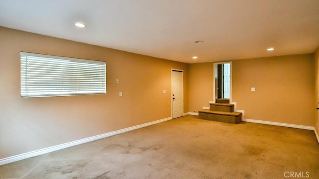 empty room featuring recessed lighting, baseboards, and carpet floors