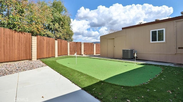 view of yard featuring a patio area, central air condition unit, and a fenced backyard