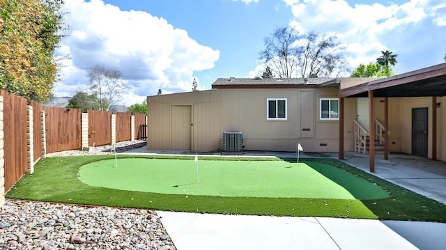 back of property featuring a patio area, central air condition unit, and a fenced backyard