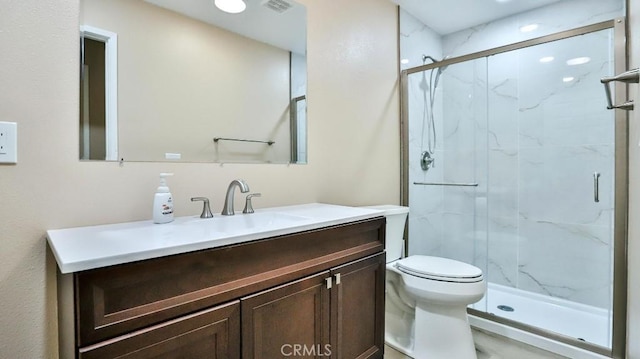 full bathroom featuring vanity, toilet, visible vents, and a marble finish shower