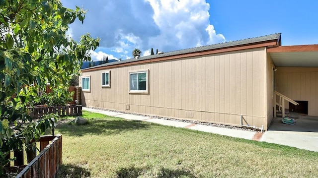 view of side of property with crawl space, a yard, and fence