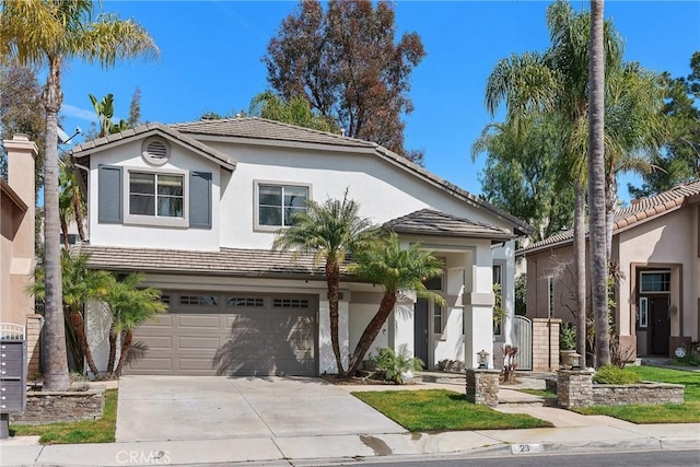 view of front of property featuring stucco siding, a garage, concrete driveway, and a tiled roof