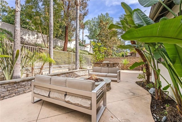 view of patio / terrace featuring an outdoor living space with a fire pit and a fenced backyard