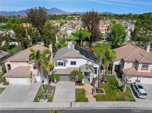 birds eye view of property with a mountain view and a residential view