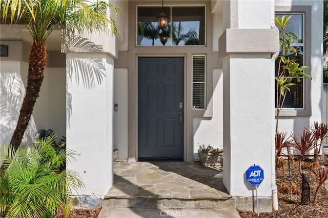 property entrance with stucco siding