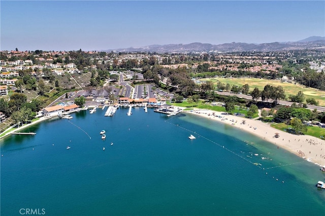 drone / aerial view featuring a water and mountain view