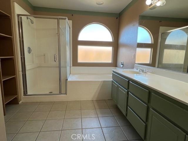 bathroom with vanity, tile patterned floors, a bath, and a stall shower