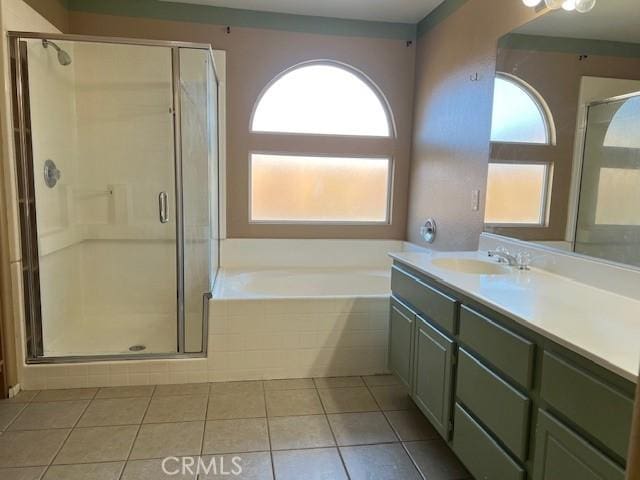 full bath featuring vanity, a shower stall, a bath, and tile patterned flooring