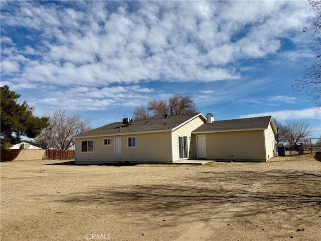 rear view of house with fence