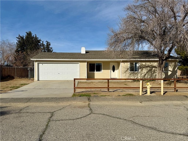 ranch-style house featuring fence, roof with shingles, concrete driveway, an attached garage, and a chimney