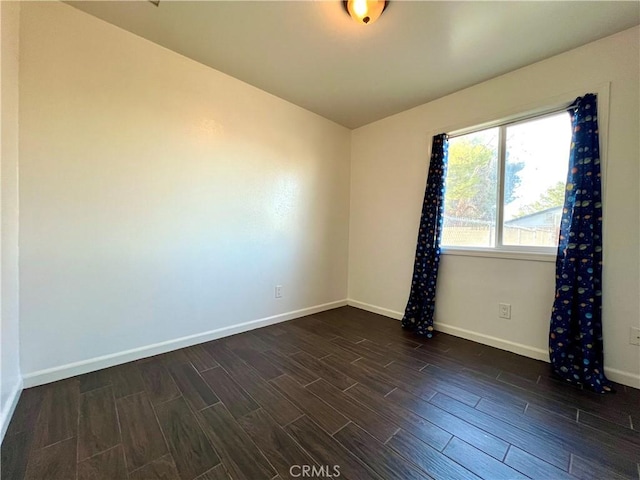 spare room with baseboards and wood tiled floor