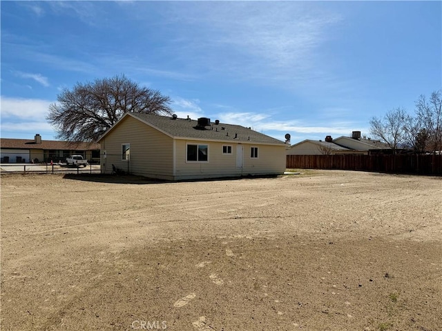 back of house with fence