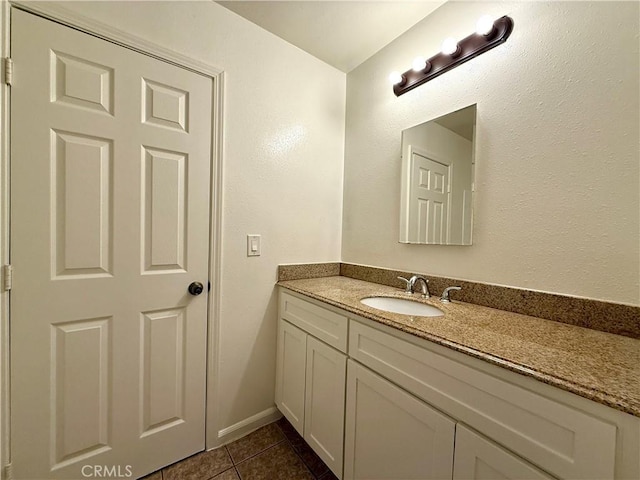 bathroom with tile patterned flooring and vanity