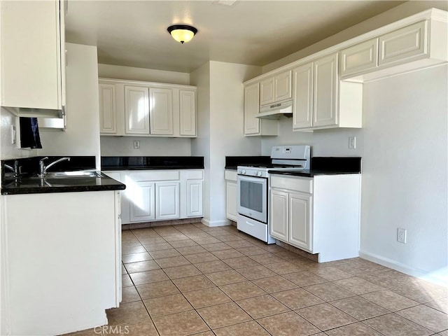 kitchen featuring white gas range, dark countertops, under cabinet range hood, and a sink