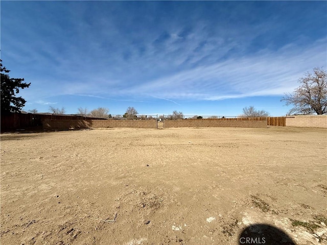 view of yard featuring a rural view and fence