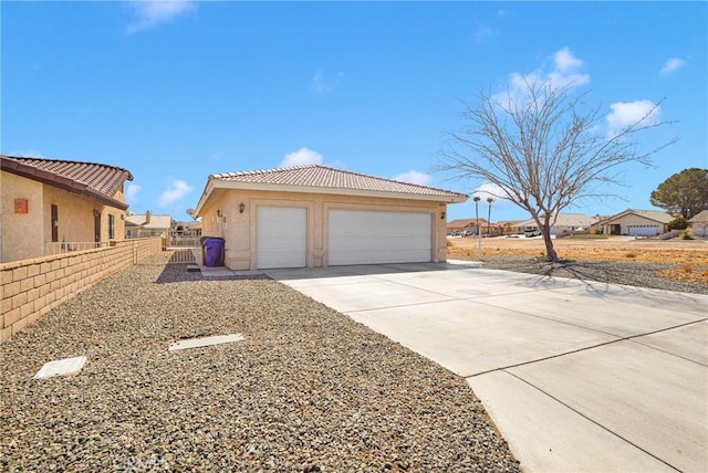 detached garage featuring fence