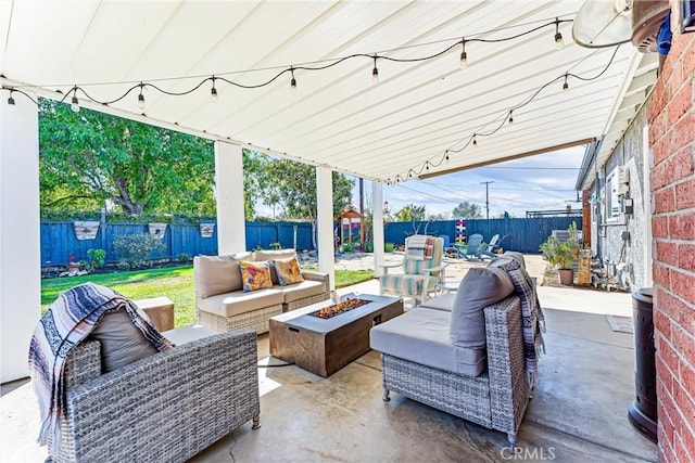 view of patio / terrace with an outdoor living space with a fire pit and a fenced backyard