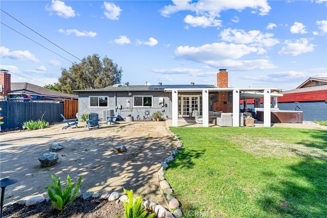 back of house with a patio, a lawn, outdoor lounge area, and fence