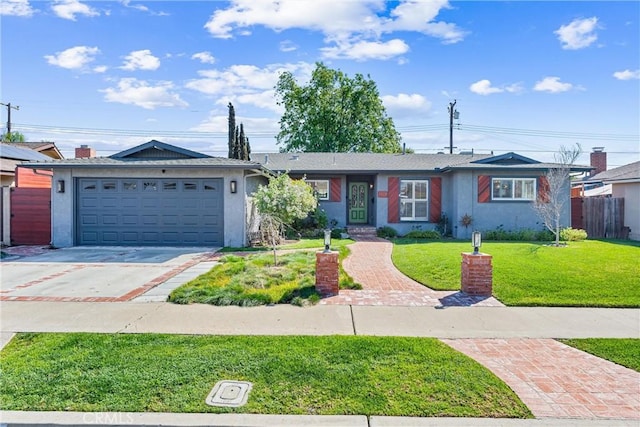 ranch-style house with a garage, concrete driveway, a front yard, and stucco siding