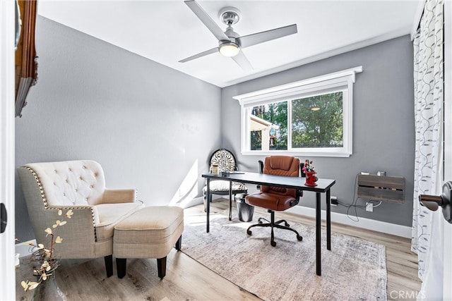 office area featuring ceiling fan, baseboards, and wood finished floors