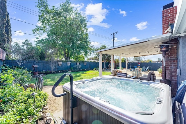 exterior space with a hot tub and a fenced backyard