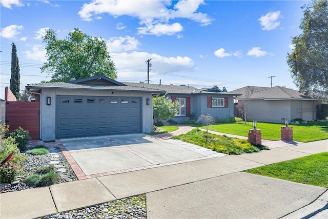 ranch-style house featuring a front yard, concrete driveway, a garage, and stucco siding