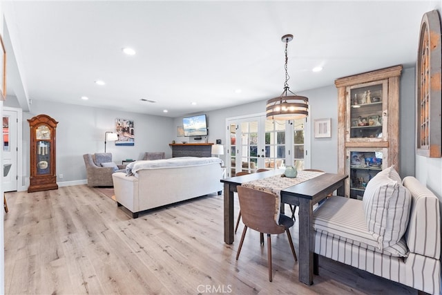 dining room featuring visible vents, light wood-style flooring, recessed lighting, french doors, and baseboards