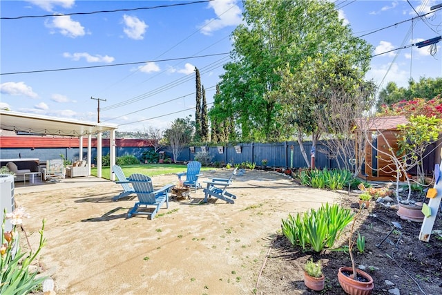 view of yard with a patio area, a fire pit, and a fenced backyard