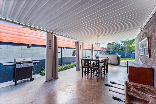 view of patio with area for grilling, outdoor dining space, and fence