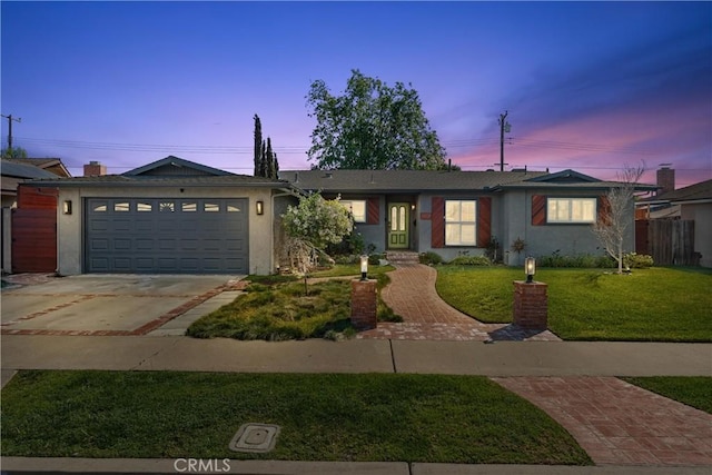 ranch-style home with stucco siding, a lawn, fence, concrete driveway, and a garage