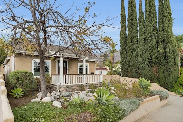 view of front of home featuring a porch and stucco siding