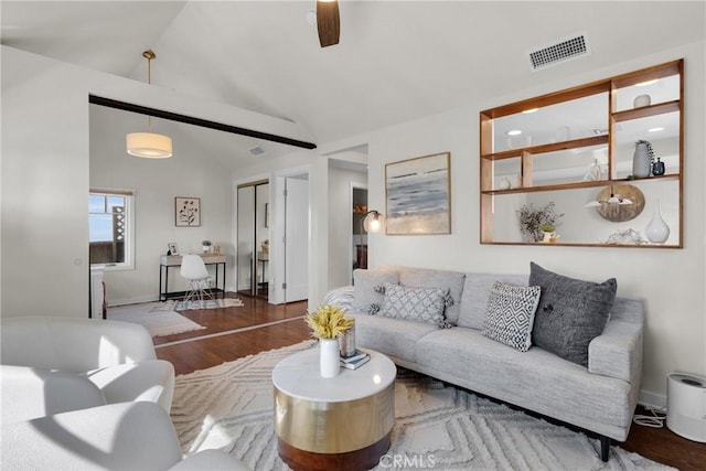 living room with lofted ceiling, wood finished floors, visible vents, and ceiling fan