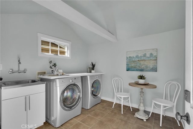 laundry room featuring tile patterned flooring, baseboards, cabinet space, independent washer and dryer, and a sink