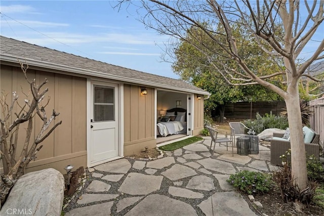 view of patio featuring an outbuilding and fence