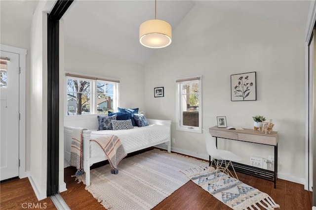 bedroom featuring multiple windows, high vaulted ceiling, baseboards, and wood finished floors