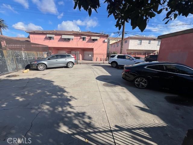 uncovered parking lot featuring fence