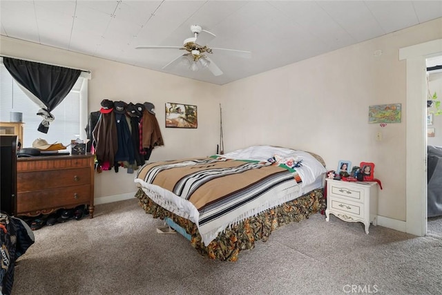 carpeted bedroom with baseboards and ceiling fan