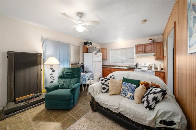 living area featuring a ceiling fan